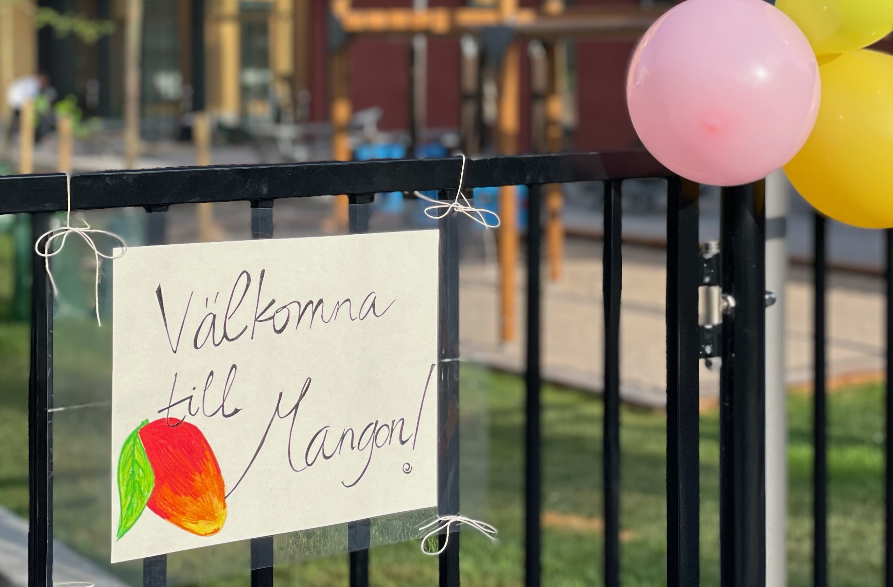 Handskriven skylt på entrén där det står: "Välkomna till Mangon!"